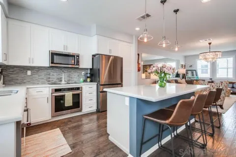 a kitchen with cabinets appliances and a sink