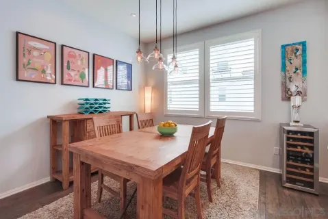 a kitchen with a table chairs sink and cabinets