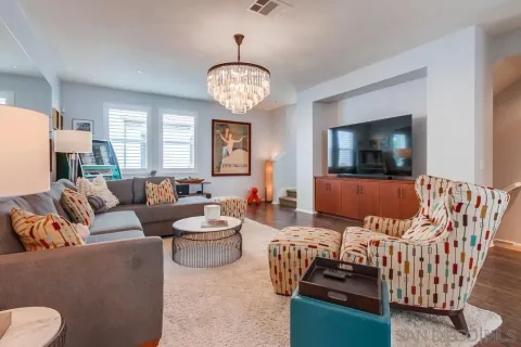 a living room with furniture a rug and a flat screen tv