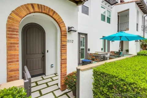 a view of a house with backyard and sitting area