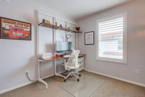 a view of a workspace with furniture and a flat screen tv