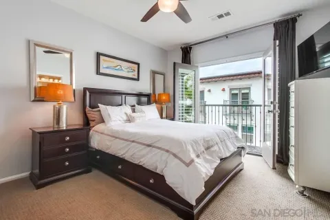 a bedroom with a bed and a flat tv screen