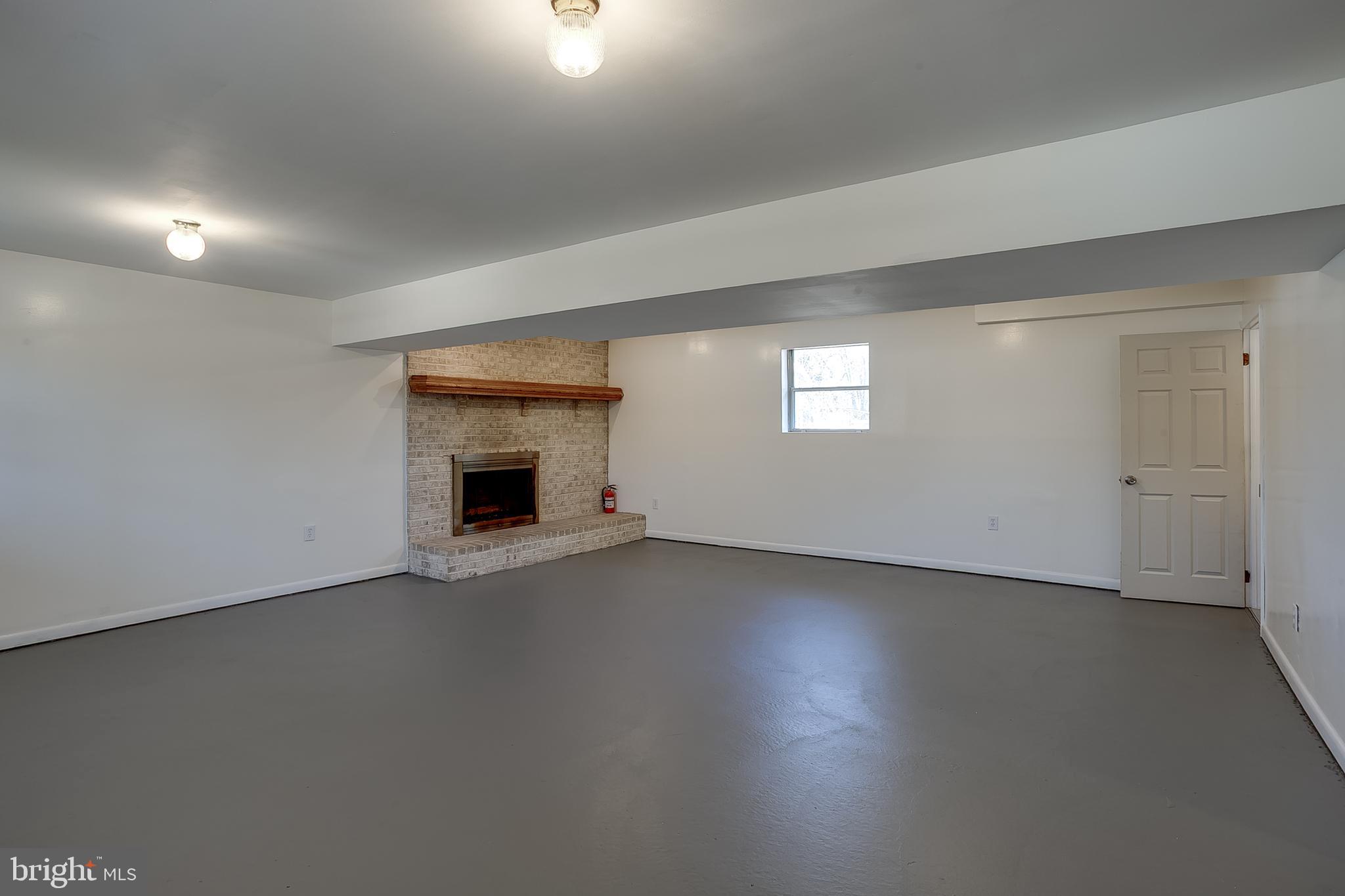 2430 Hopewell Road Berlin, NJ 08009 - Photo 21 of 30 an empty room with a fireplace and window