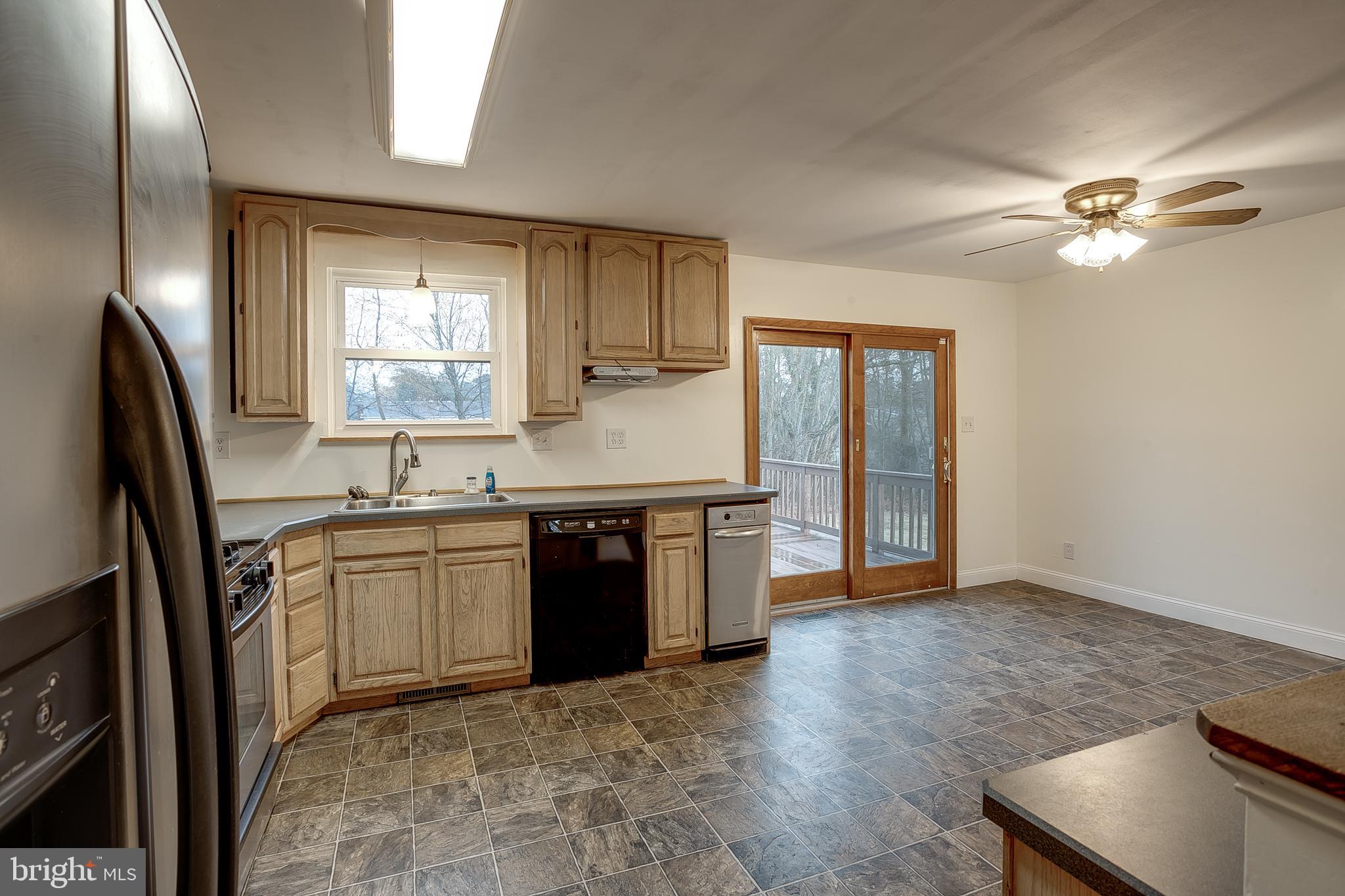 2430 Hopewell Road Berlin, NJ 08009 - Photo 9 of 30 a kitchen with stainless steel appliances granite countertop a sink stove and refrigerator