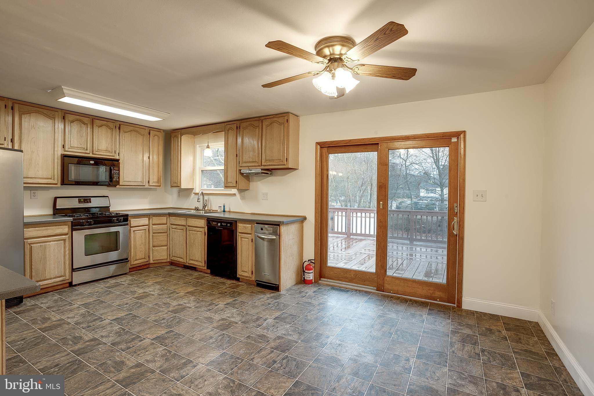 2430 Hopewell Road Berlin, NJ 08009 - Photo 10 of 30 a kitchen with a refrigerator a sink a stove a microwave and cabinets