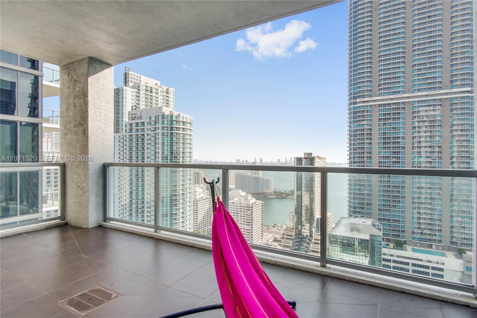 1050 Brickell Avenue, Unit 3406 Miami, FL 33131 - Photo 14 of 20 a view of a balcony with floor to ceiling window and wooden floor