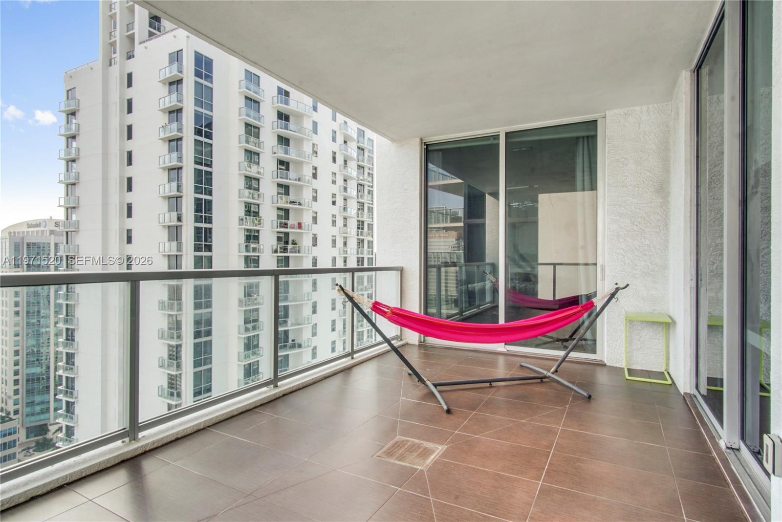 1050 Brickell Avenue, Unit 3406 Miami, FL 33131 - Photo 15 of 20 a blue chair sitting in front of a window