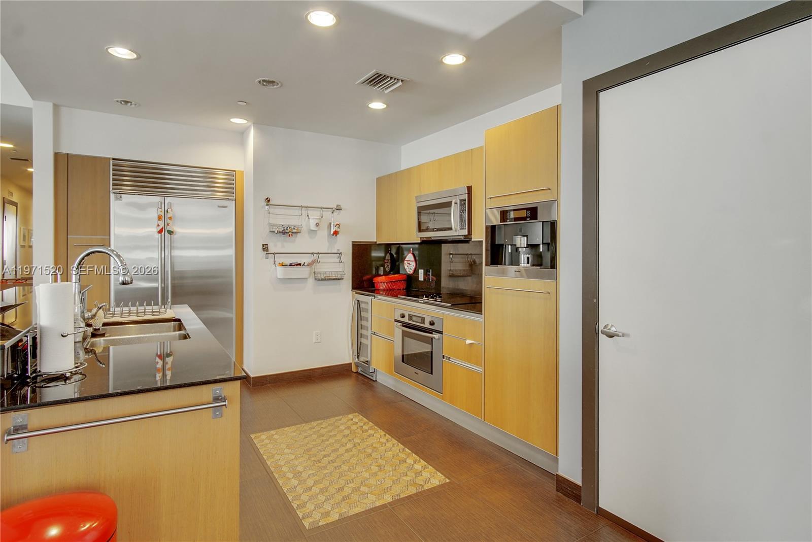 1050 Brickell Avenue, Unit 3406 Miami, FL 33131 - Photo 3 of 20 a kitchen with stainless steel appliances granite countertop a refrigerator and a stove
