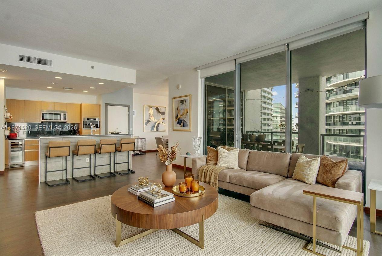 1050 Brickell Avenue, Unit 3406 Miami, FL 33131 - Photo 4 of 20 a living room with furniture and a large window