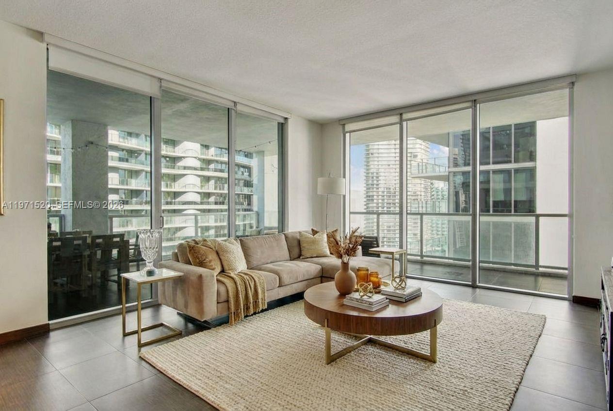 1050 Brickell Avenue, Unit 3406 Miami, FL 33131 - Photo 5 of 20 a living room with furniture and a floor to ceiling window