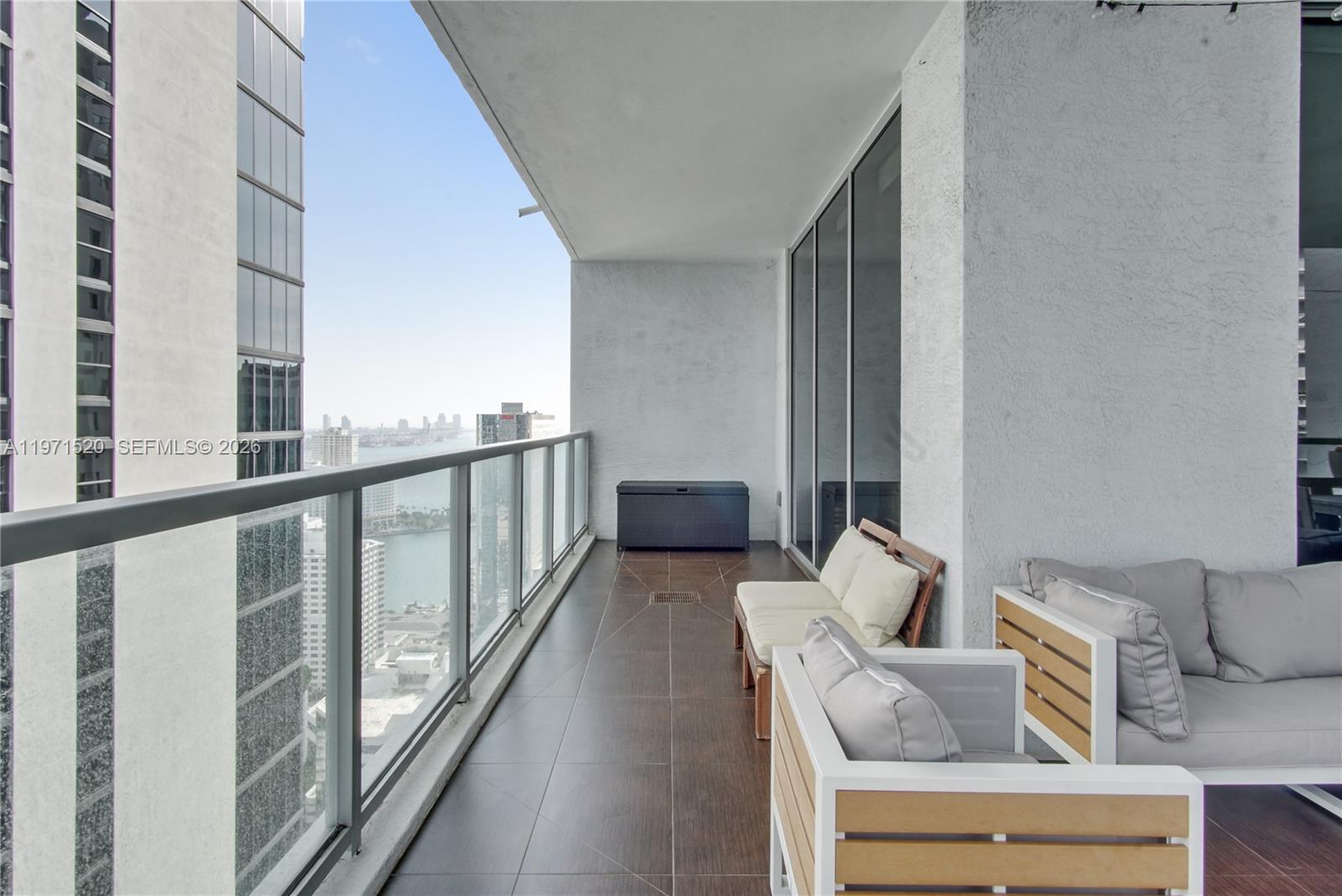 1050 Brickell Avenue, Unit 3406 Miami, FL 33131 - Photo 6 of 20 a balcony with outdoor seating and stairs
