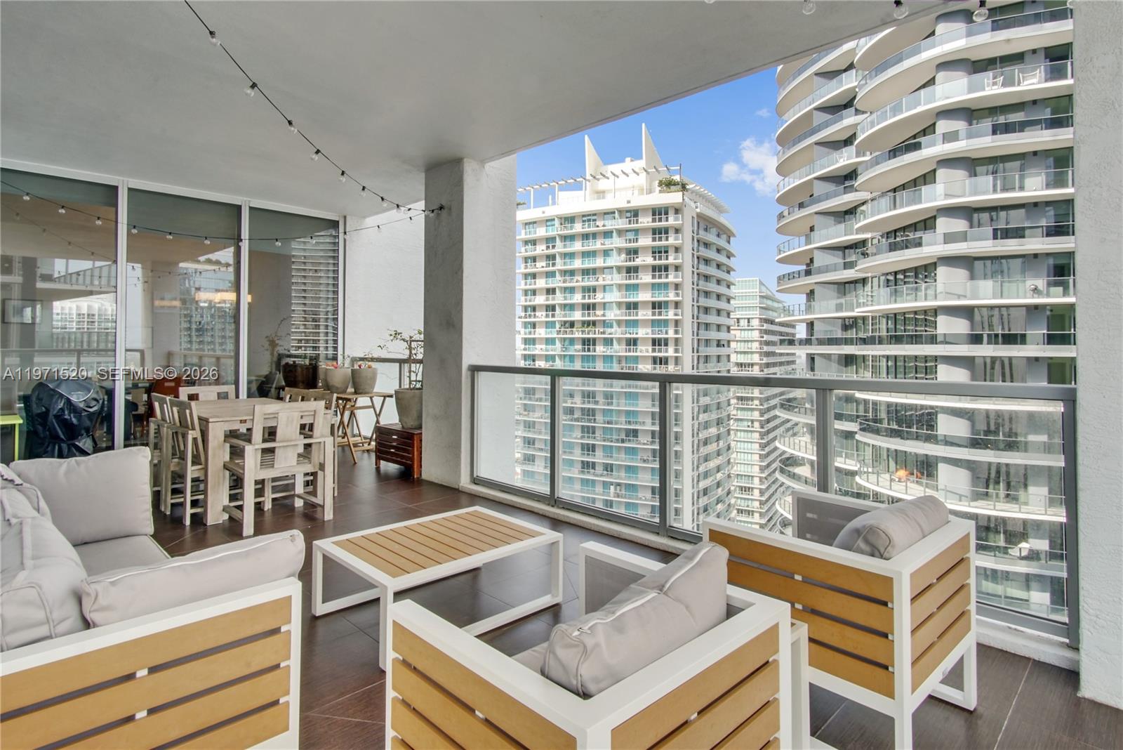 1050 Brickell Avenue, Unit 3406 Miami, FL 33131 - Photo 7 of 20 a kitchen with a table chairs and a chandelier