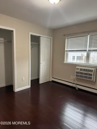 a view of a room with wooden floor and windows