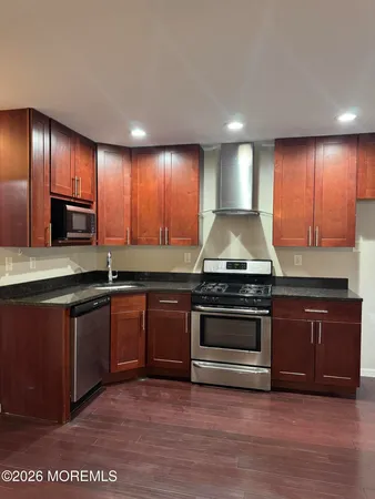 a kitchen with granite countertop stainless steel appliances and cabinets