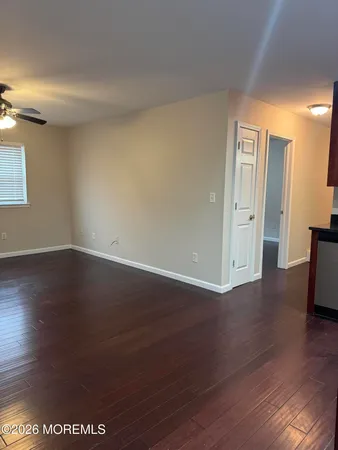 a kitchen with stainless steel appliances kitchen island granite countertop a stove cabinets and wooden floor