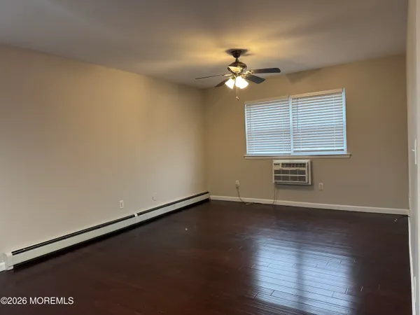 a view of a room with wooden floor and window