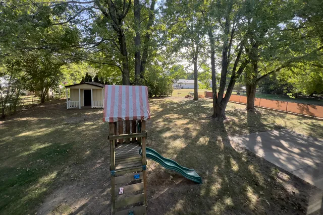 a view of a backyard with sitting area