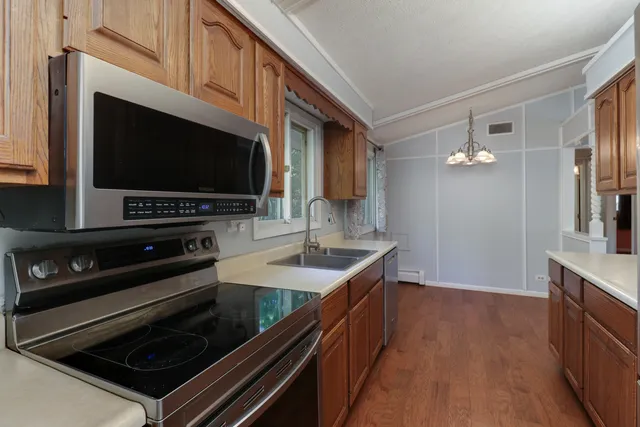 a kitchen with sink stove and microwave