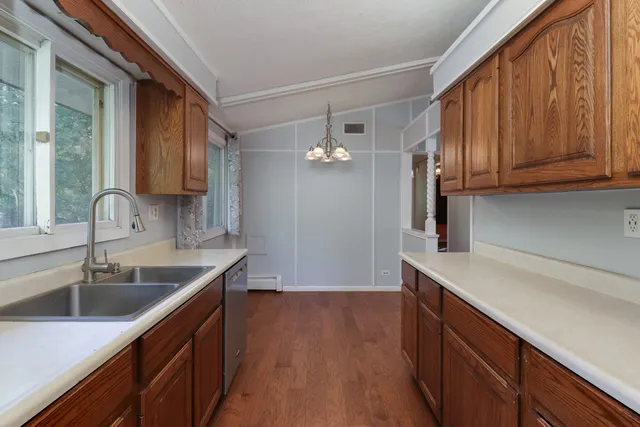 a kitchen with a sink cabinets and wooden floor