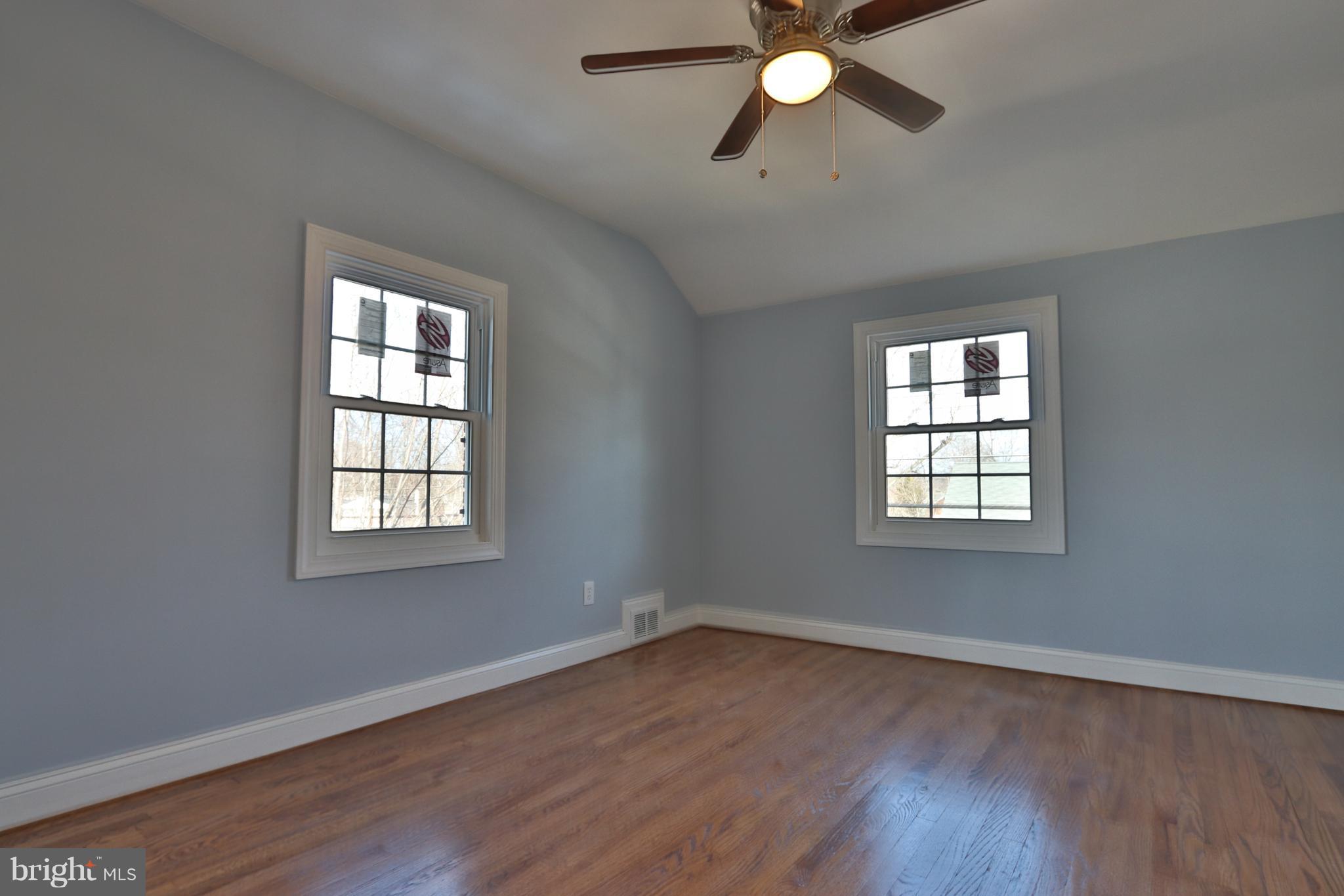 6016 Backlick Road Springfield, VA 22150 - Photo 11 of 24 an empty room with wooden floor fan and windows