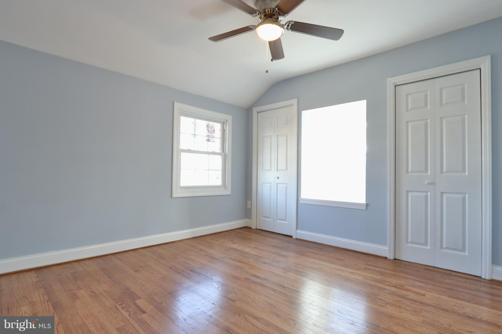 6016 Backlick Road Springfield, VA 22150 - Photo 12 of 24 a view of an empty room with wooden floor and a window