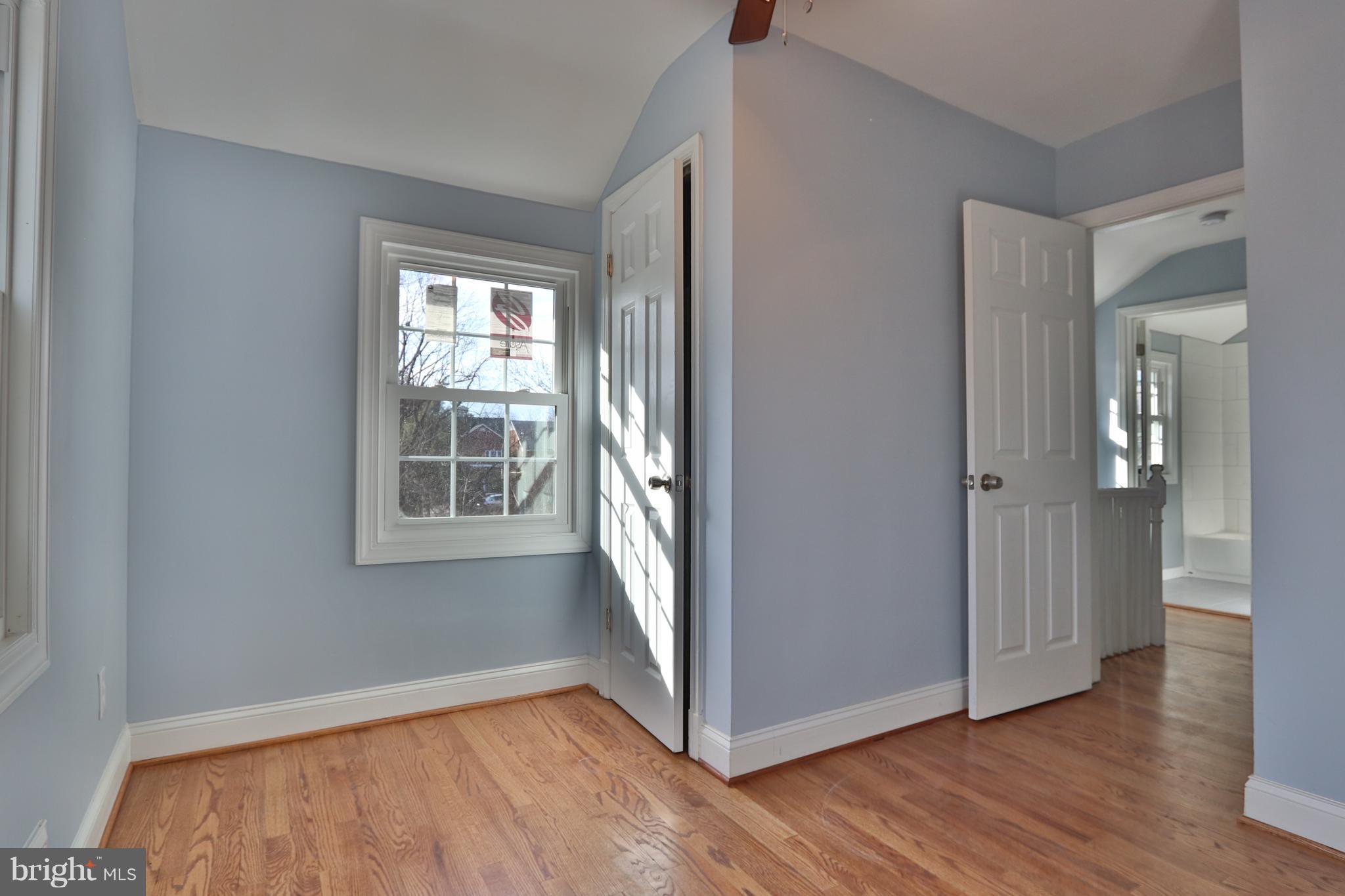 6016 Backlick Road Springfield, VA 22150 - Photo 13 of 24 an empty room with wooden floor and windows
