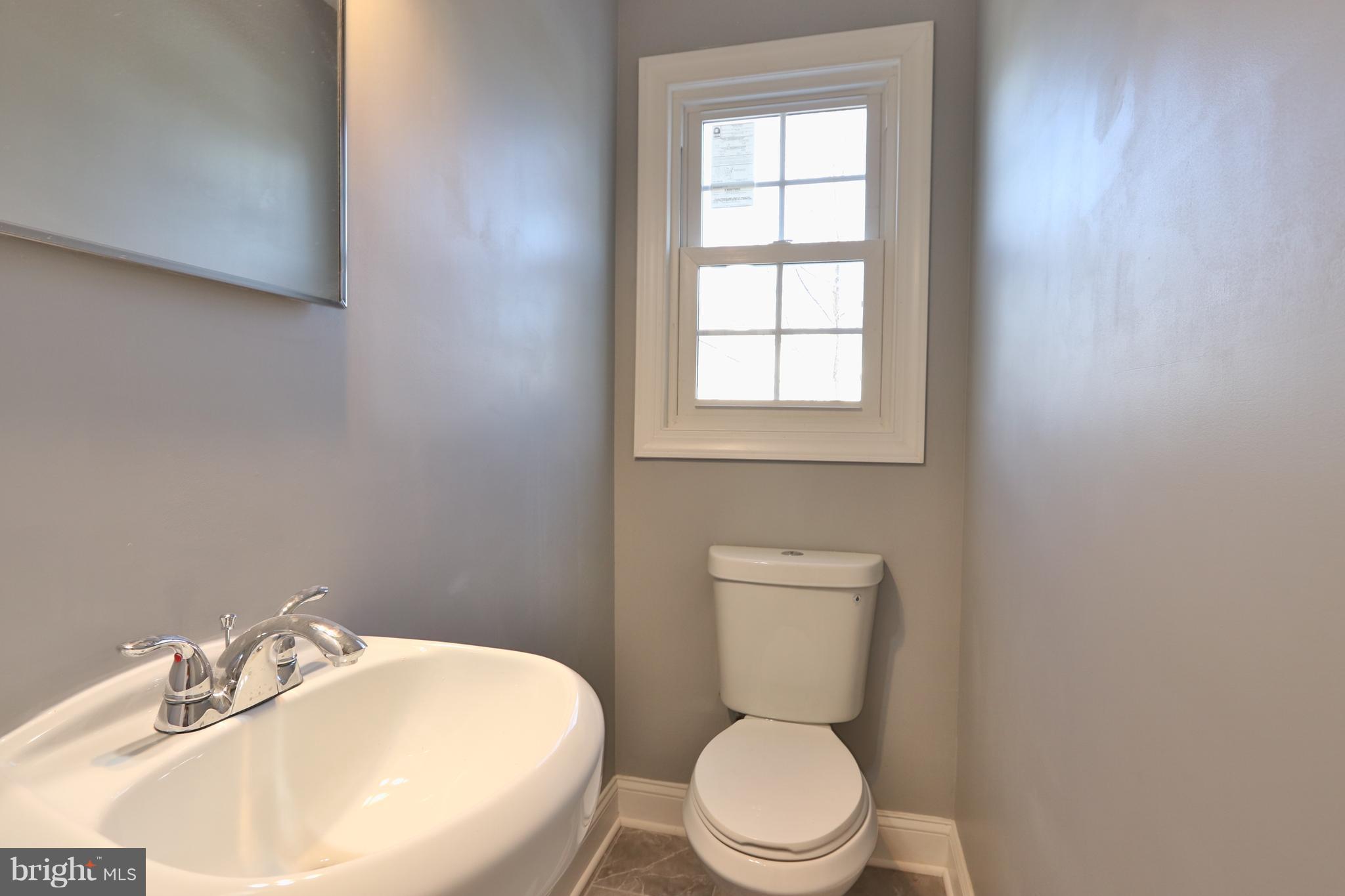 6016 Backlick Road Springfield, VA 22150 - Photo 14 of 24 a white toilet sitting next to a bathroom sink