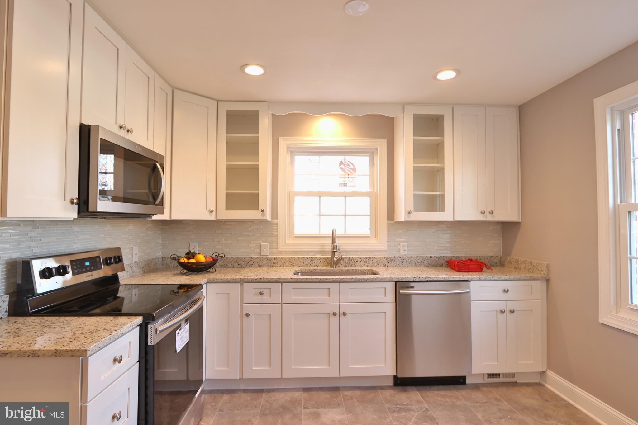 6016 Backlick Road Springfield, VA 22150 - Photo 3 of 24 a kitchen with sink cabinets and window