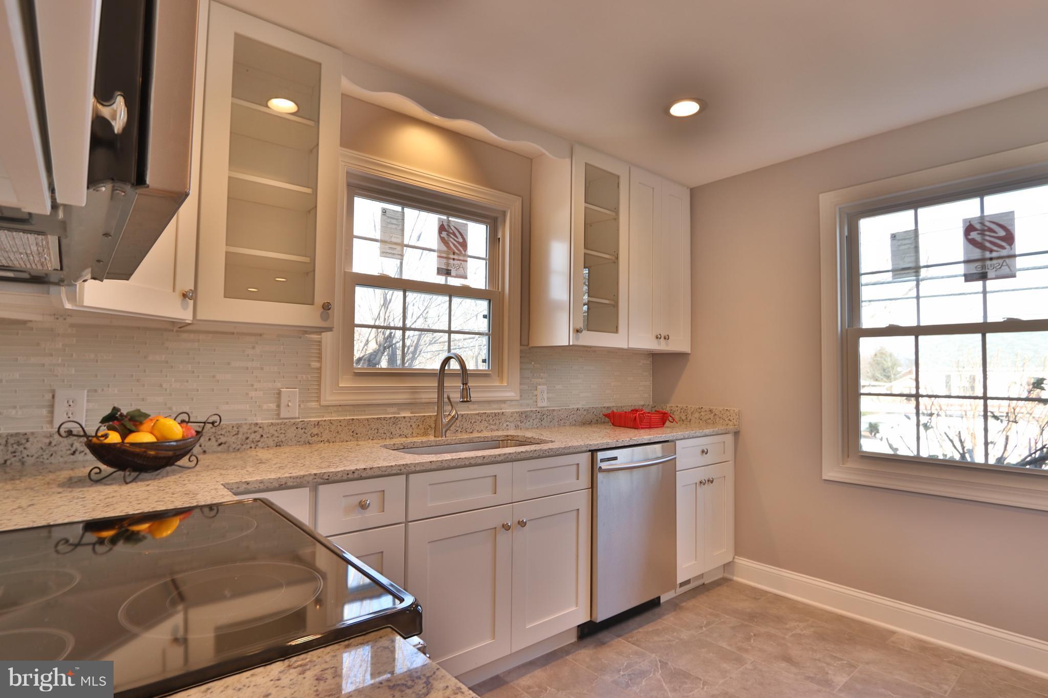 6016 Backlick Road Springfield, VA 22150 - Photo 5 of 24 a kitchen with a sink window and cabinets