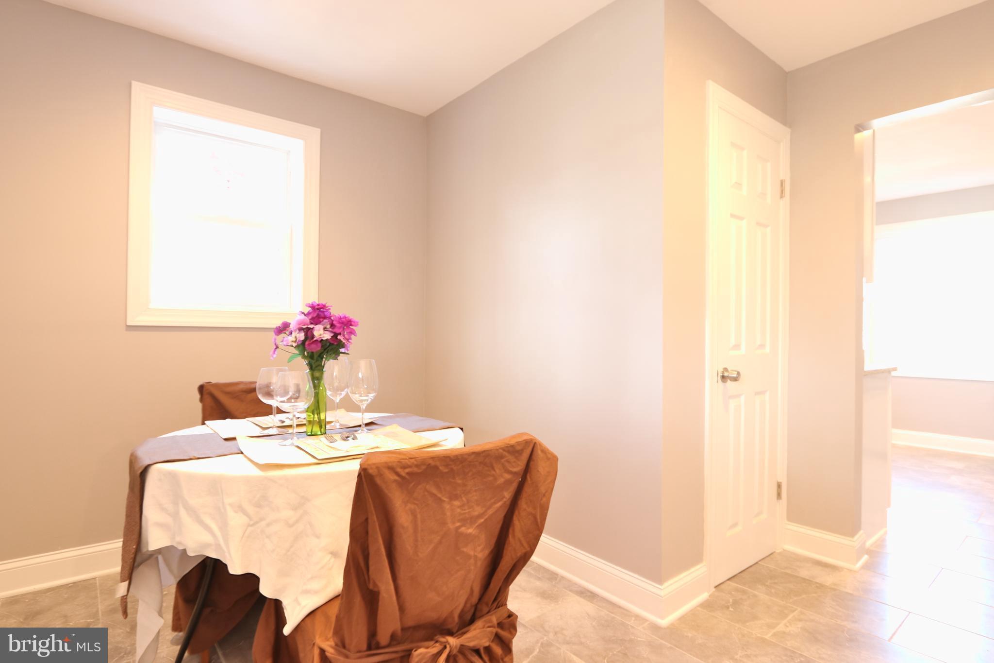 6016 Backlick Road Springfield, VA 22150 - Photo 9 of 24 a dining room with furniture and flowers