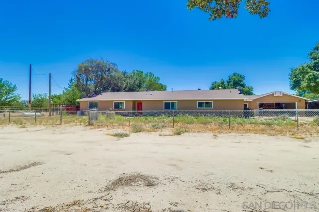 a view of a dirt road and a building