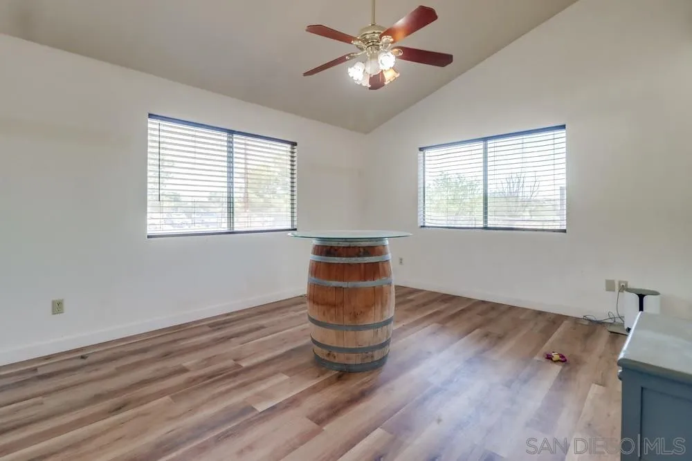 2920 Ribbonwood Road Boulevard, CA 91905 - Photo 13 of 65 a view of an empty room with a window and wooden floor