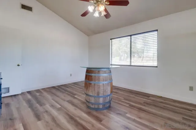 a kitchen with white cabinets and refrigerator
