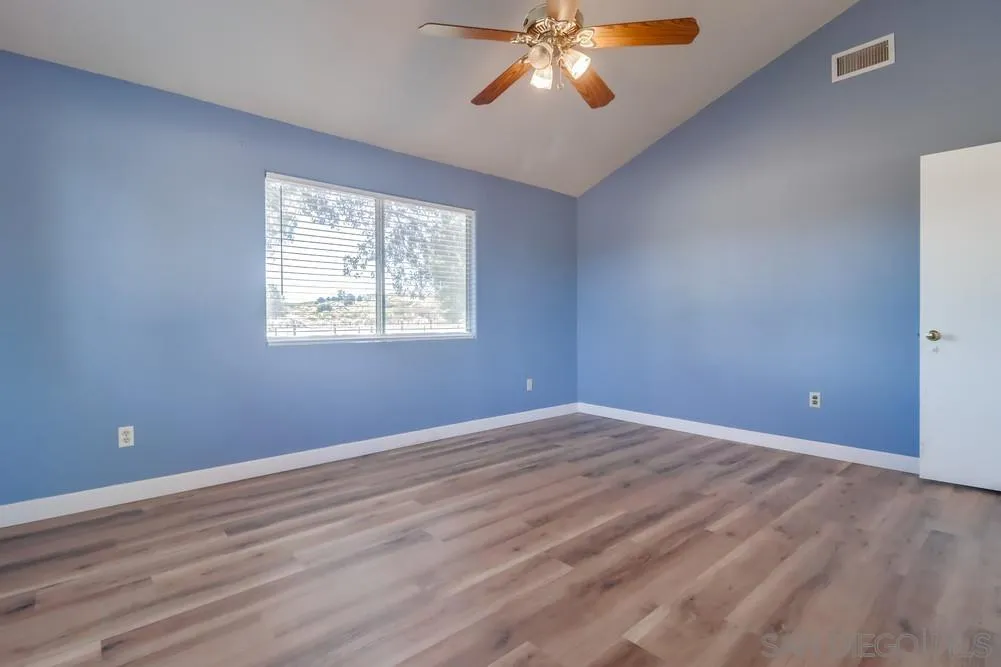 2920 Ribbonwood Road Boulevard, CA 91905 - Photo 18 of 65 a view of an empty room with a window and wooden floor