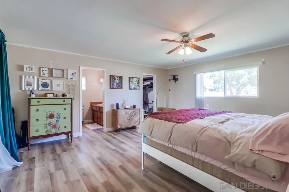2920 Ribbonwood Road Boulevard, CA 91905 - Photo 28 of 65 a bedroom with a bed and wooden floor