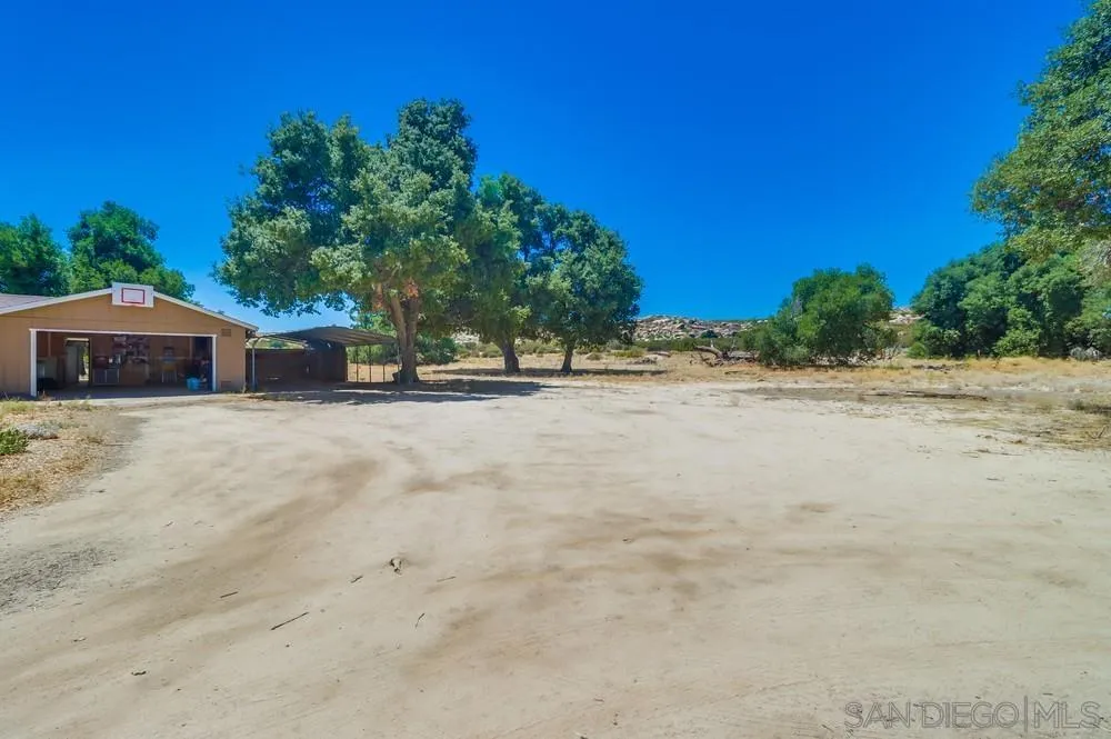 2920 Ribbonwood Road Boulevard, CA 91905 - Photo 35 of 65 a front view of a house with a yard and trees