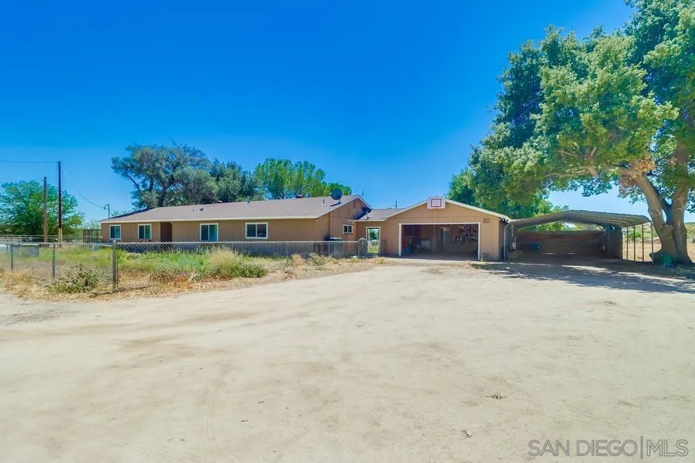 2920 Ribbonwood Road Boulevard, CA 91905 - Photo 36 of 65 a front view of a house with a yard and potted plants