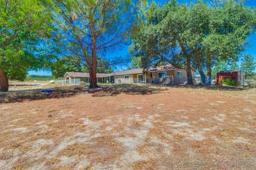 2920 Ribbonwood Road Boulevard, CA 91905 - Photo 47 of 65 a view of a house with a yard and large trees