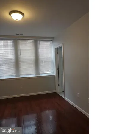 a view of room with window and wooden floor
