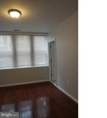 a view of room with window and wooden floor