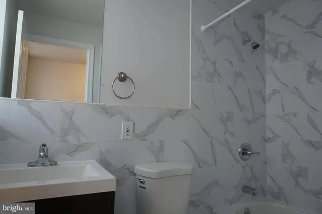 a bathroom with a sink toilet and vanity