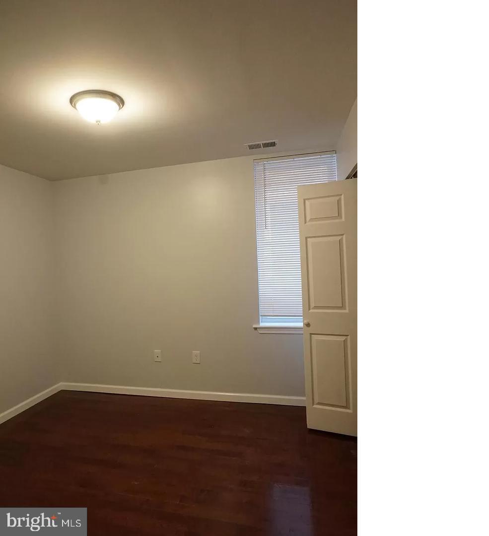 4945 Chestnut Street Philadelphia, PA 19139 - Photo 6 of 9 a view of an empty room with wooden floor