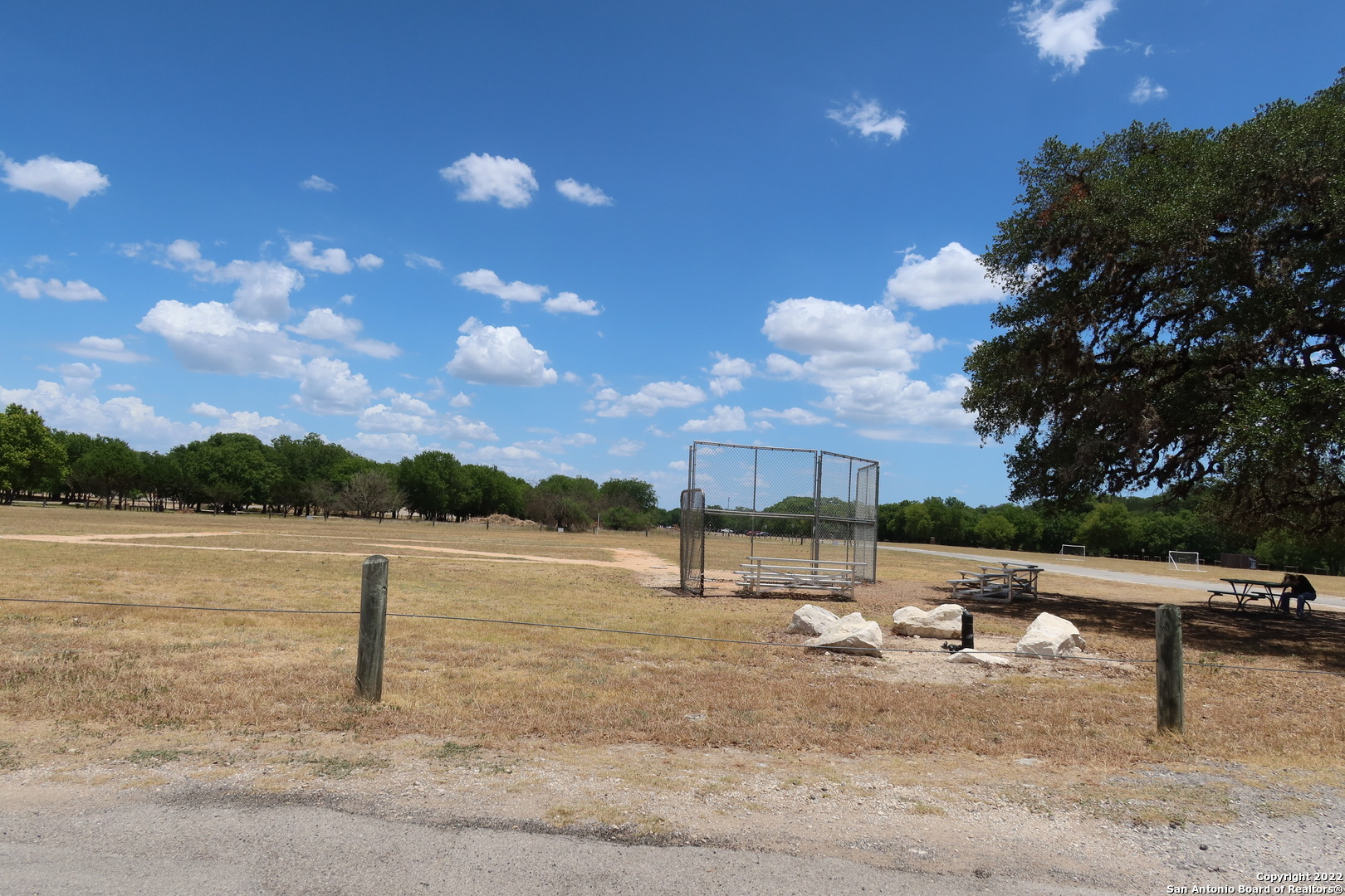 Tbd Cypress Bandera, TX 78003 - Photo 9 of 12 a view of a lake with a yard and outdoor seating