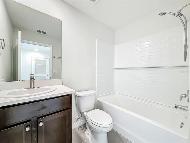 a view of a house with pool and sitting area