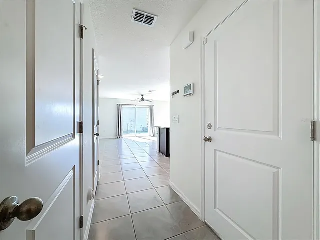 a view of a hallway with wooden shelves