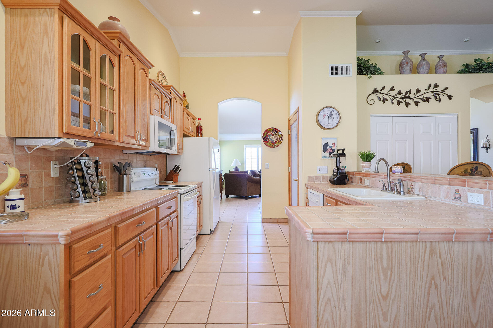 7344 North Alsup Road Litchfield Park, AZ 85340 - Photo 12 of 62 a kitchen with stainless steel appliances granite countertop a sink and cabinets