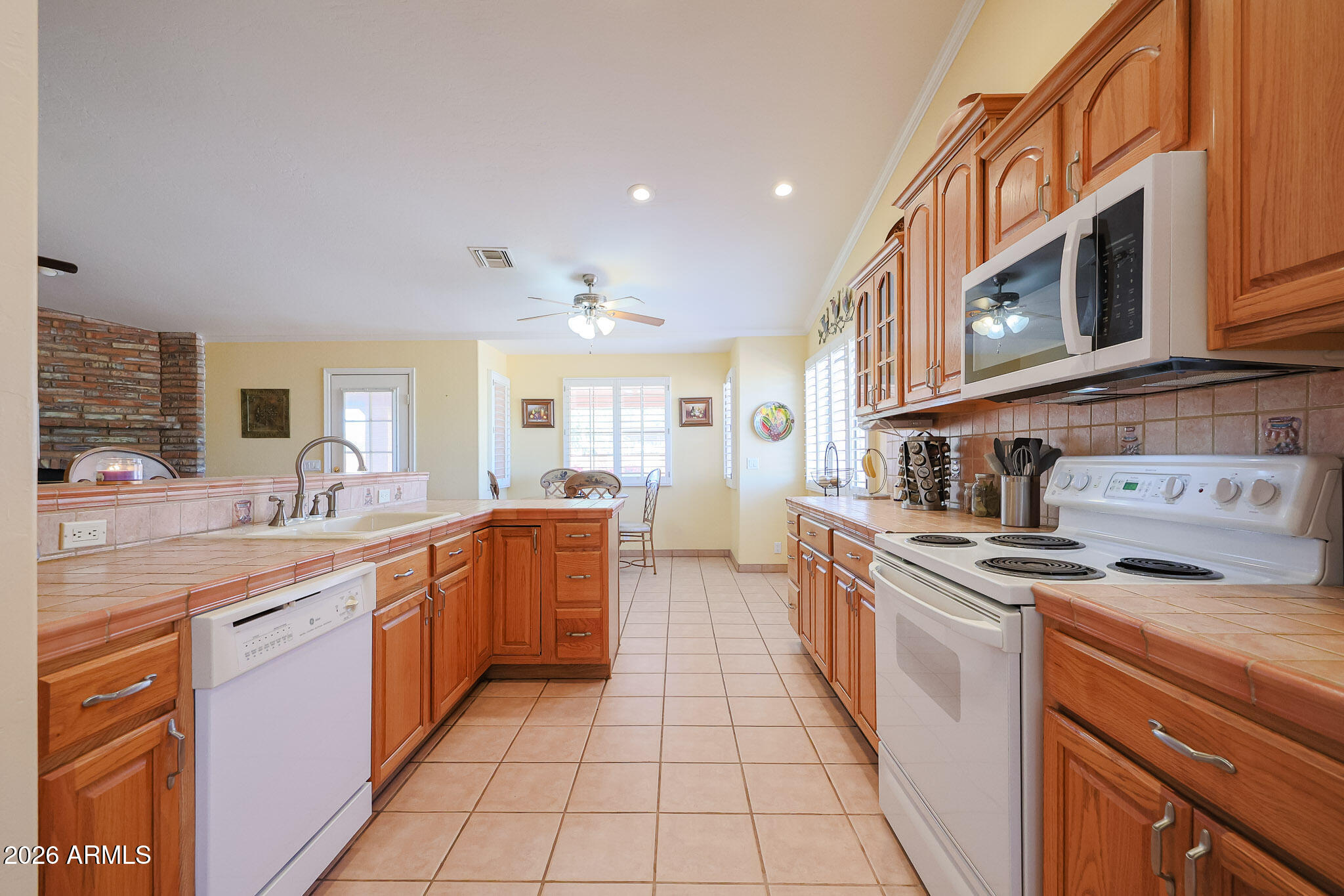 7344 North Alsup Road Litchfield Park, AZ 85340 - Photo 13 of 62 a kitchen with stainless steel appliances granite countertop a sink and cabinets