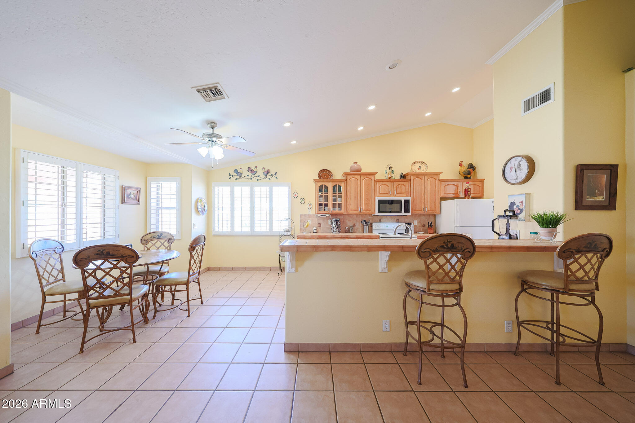 7344 North Alsup Road Litchfield Park, AZ 85340 - Photo 19 of 62 a dining room with furniture and a chandelier