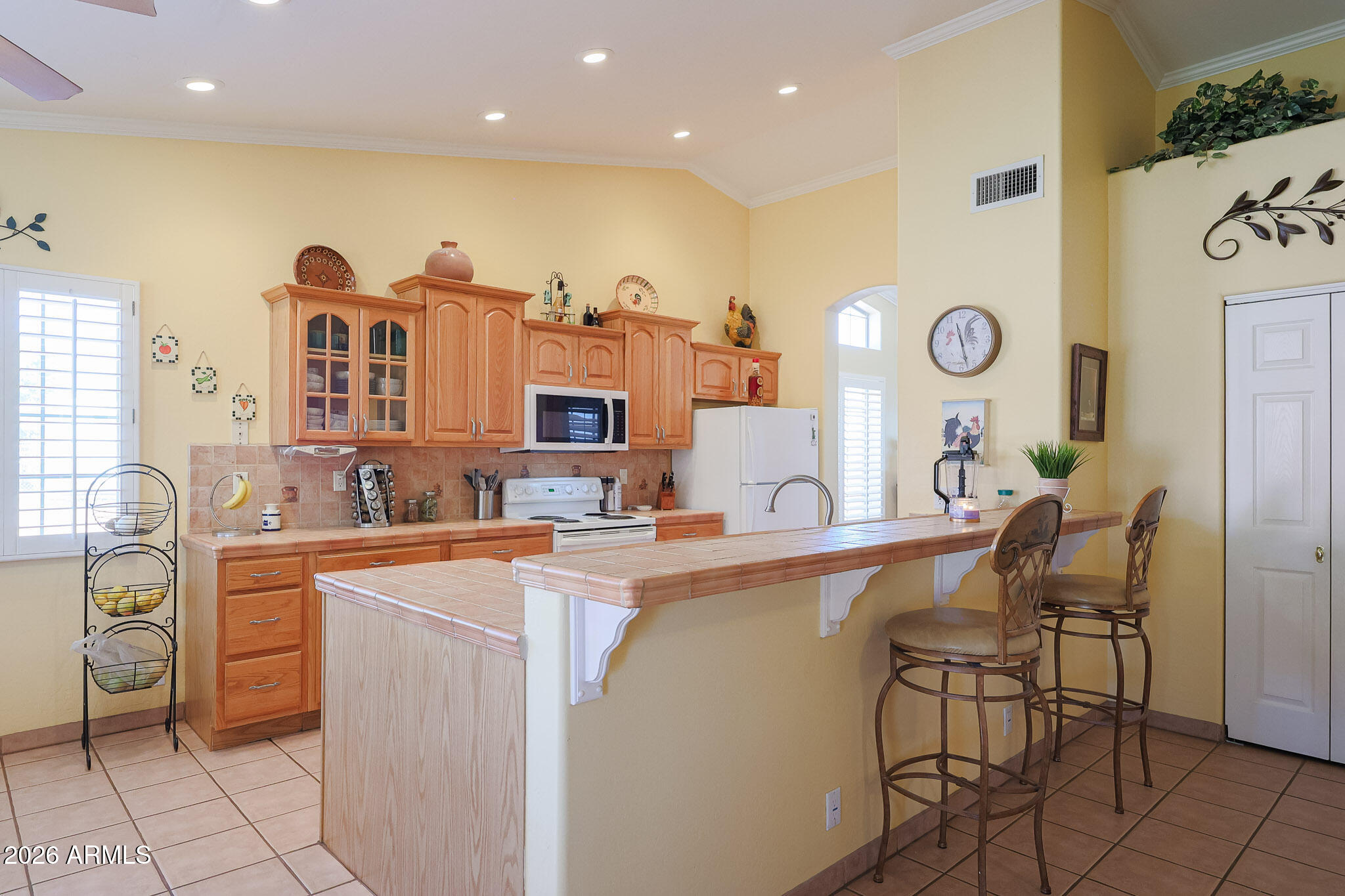 7344 North Alsup Road Litchfield Park, AZ 85340 - Photo 20 of 62 a kitchen with cabinets a sink and chairs