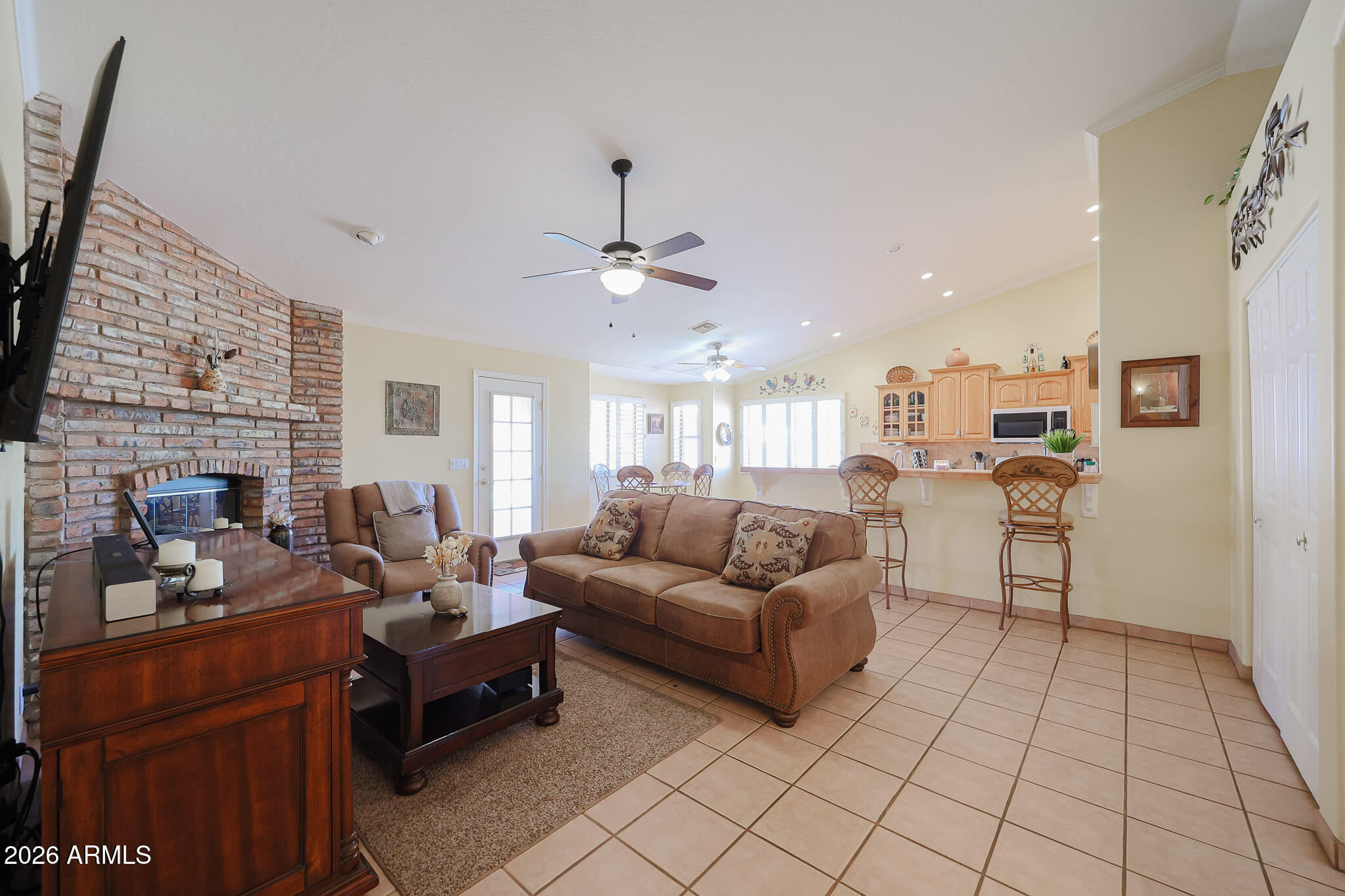 7344 North Alsup Road Litchfield Park, AZ 85340 - Photo 25 of 62 a living room with furniture and a fireplace